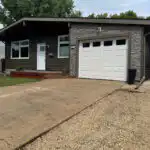 Winnipeg home renovation dark siding stone accents contractor