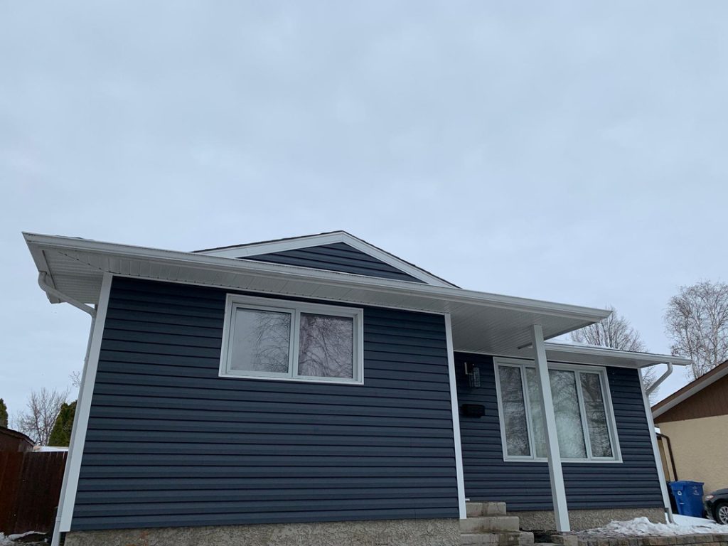 Blue house new siding trim windows winnipeg home renovation remodeling contractor exterior soffit fascia a87ef026 0a8f 438b bcdb d97d7cea1231