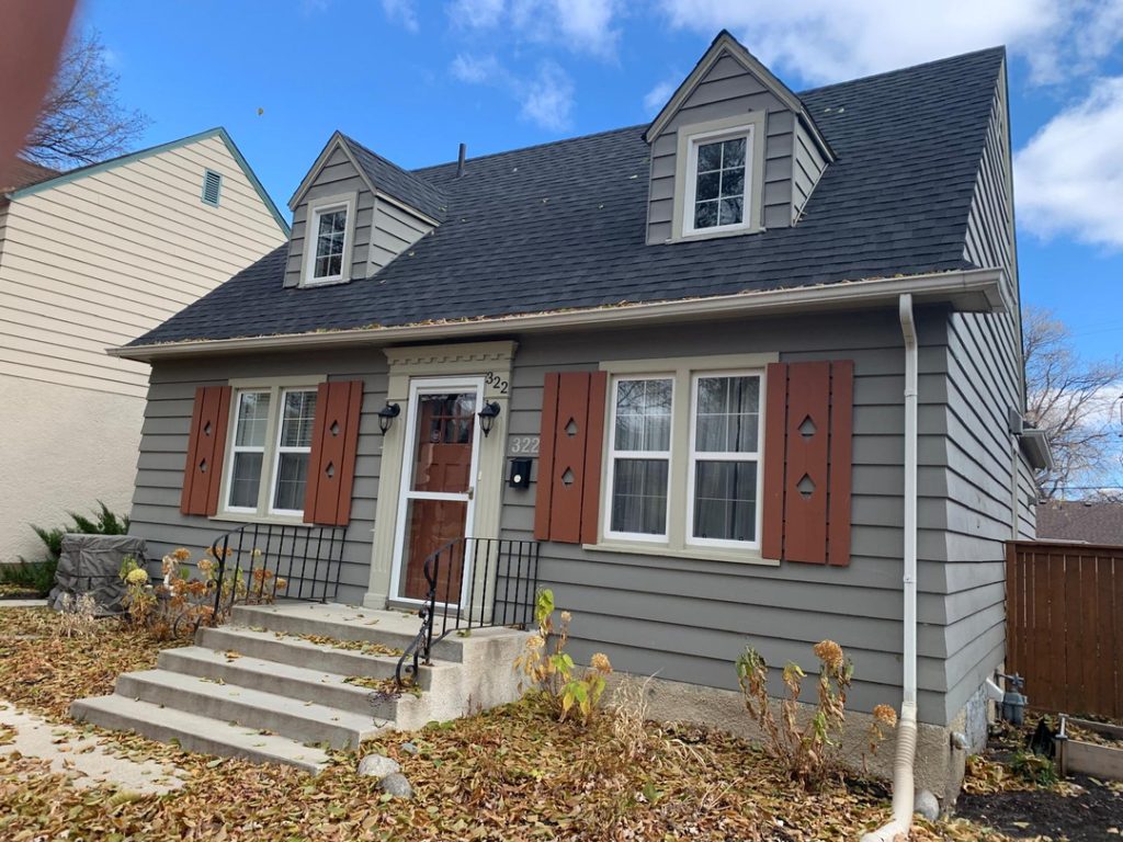 Charming house gray siding red shutters steep roof dormer windows winnipeg contractor renovation siding gutter exterior 6b2e8c04 91c3 4dc4 af81 44bb72614e27