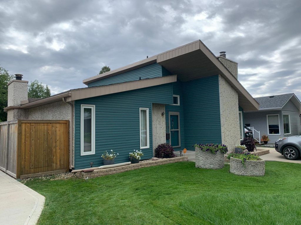 Modern home renovation winnipeg general contractor teal siding stone accents exterior renovations 128f39ea fbc0 44b2 816d a8040c08da4e