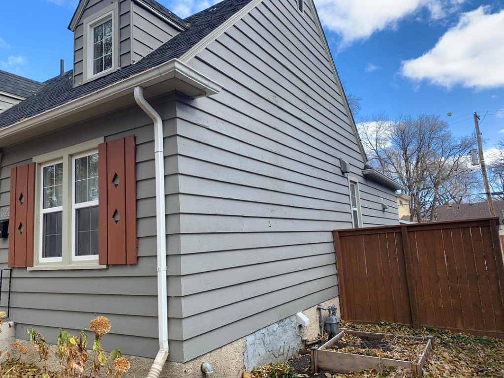 Modern renovations general contractor winnipeg home exterior renovation gray siding brown shutters white trim e2bd32f9 64c4 46c8 a7ba d4f2c518748a