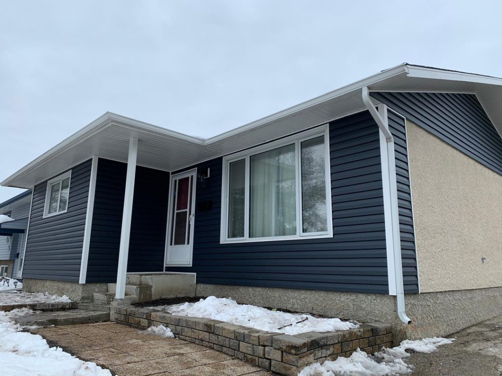 Winnipeg home renovation contractor dark blue siding white trim snowy landscape 67fccaa7 22a3 4641 b284 e34bfcf033e0
