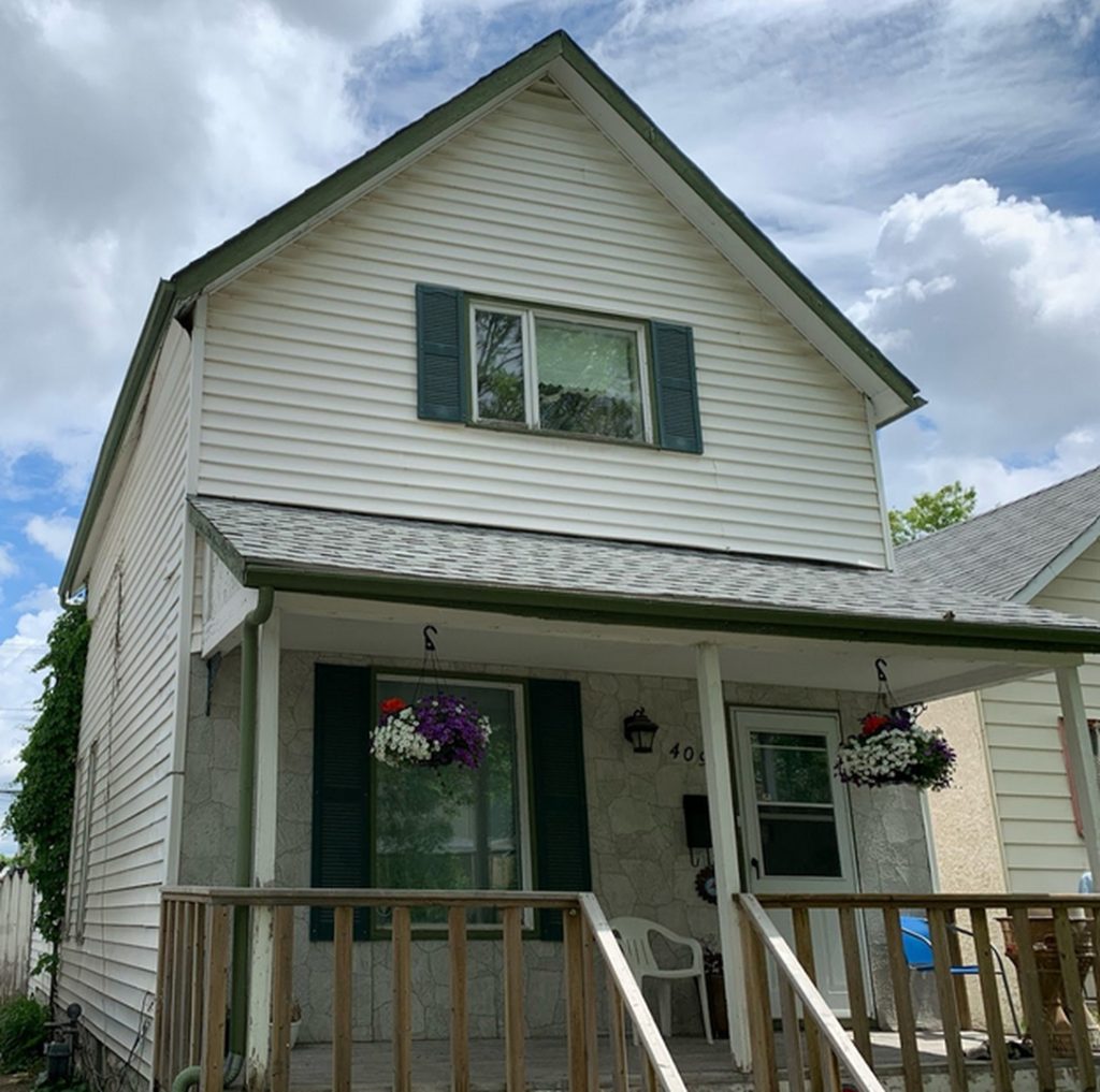 Winnipeg home renovation contractor white siding green shutters exterior renovations c128d972 ccc0 4c51 a360 53428902693c