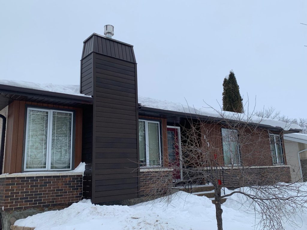 Winnipeg home renovation dark brown siding modern window design brick chimney 93e1efa6 1863 4663 9194 f91f6ba2ce83