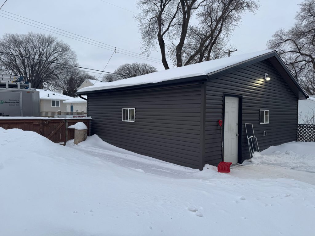 Winnipeg modern renovations dark grey vinyl garage contractor roofing siding home renovation exterior ab8e2621 b195 483a 9ccf aefef5f6aed1